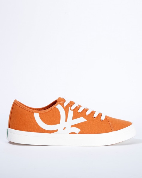 Ucb store orange sneakers