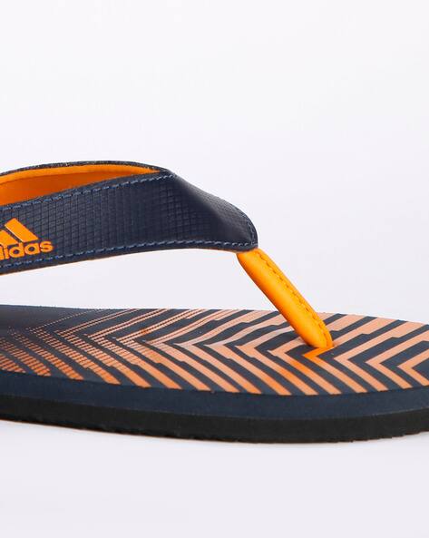orange adidas flip flops