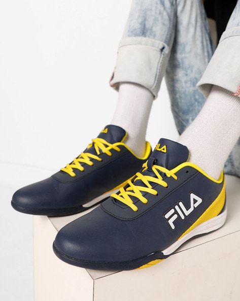 blue and yellow fila shoes