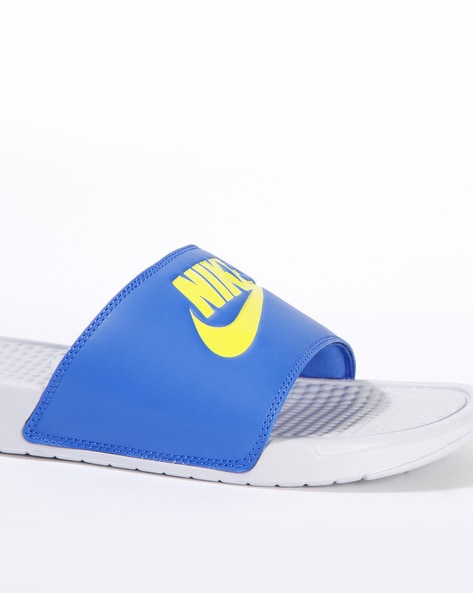 blue and yellow nike slides