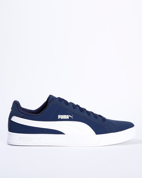 navy blue and white pumas